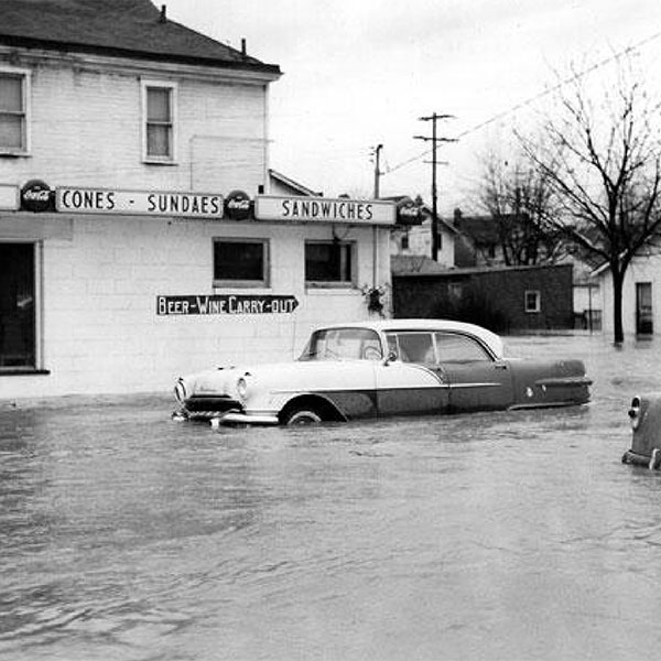 American vintage car in a flood by a diner
