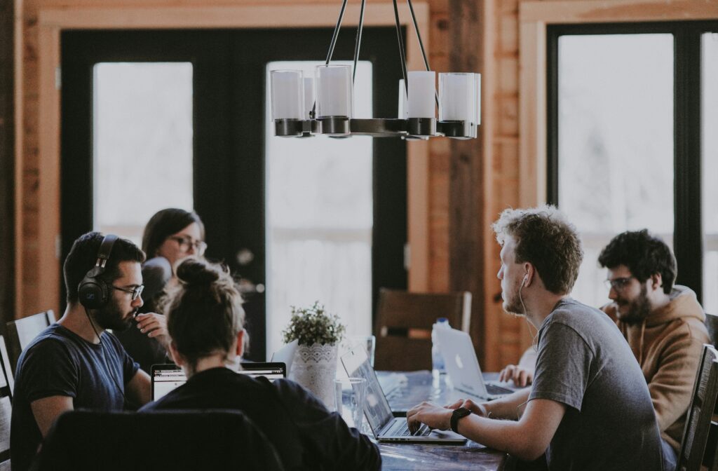 Decorative image of a team of people working together in a conference room