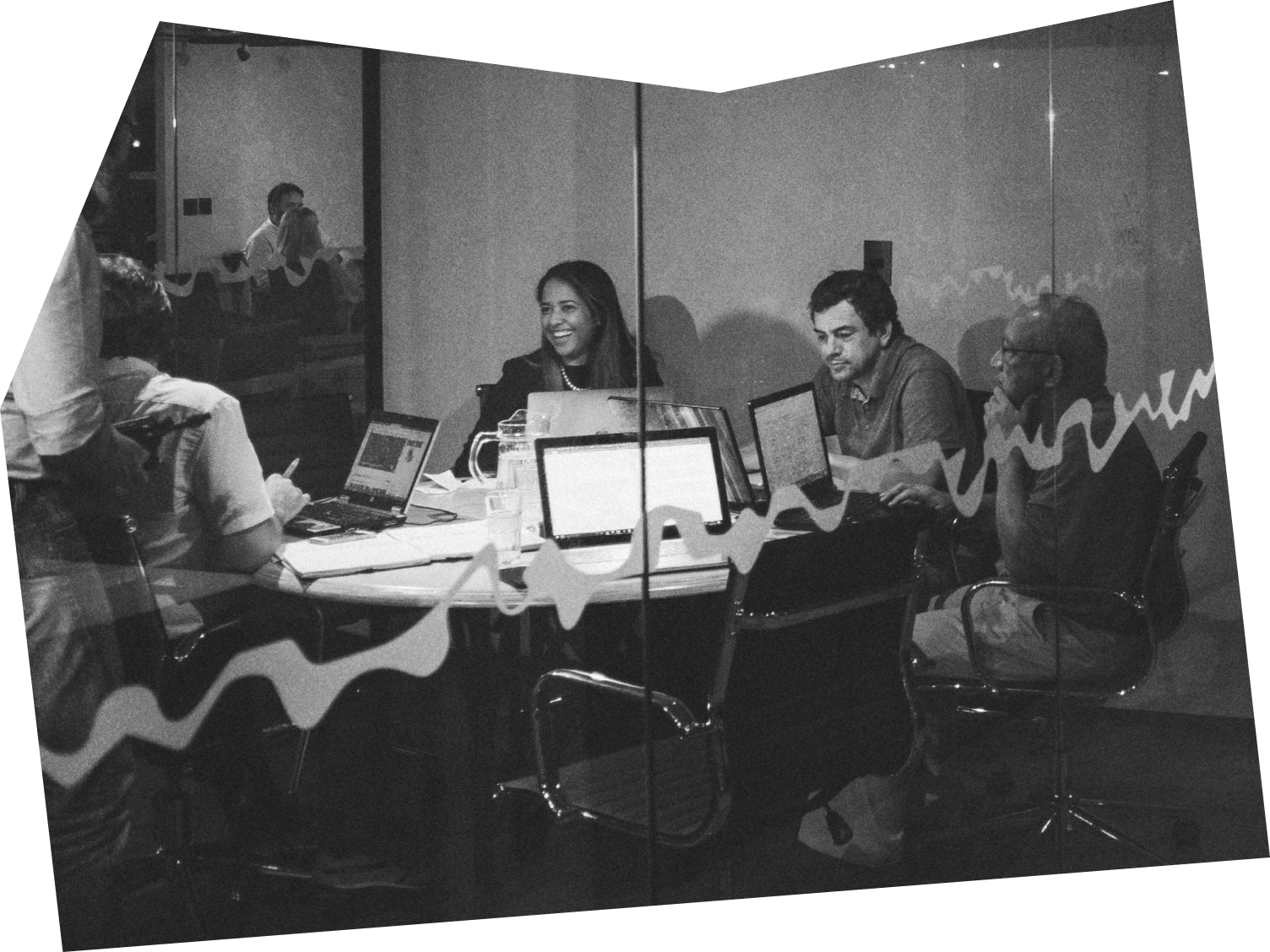 Decorative image of a group of people sitting around a table having a lively discussion